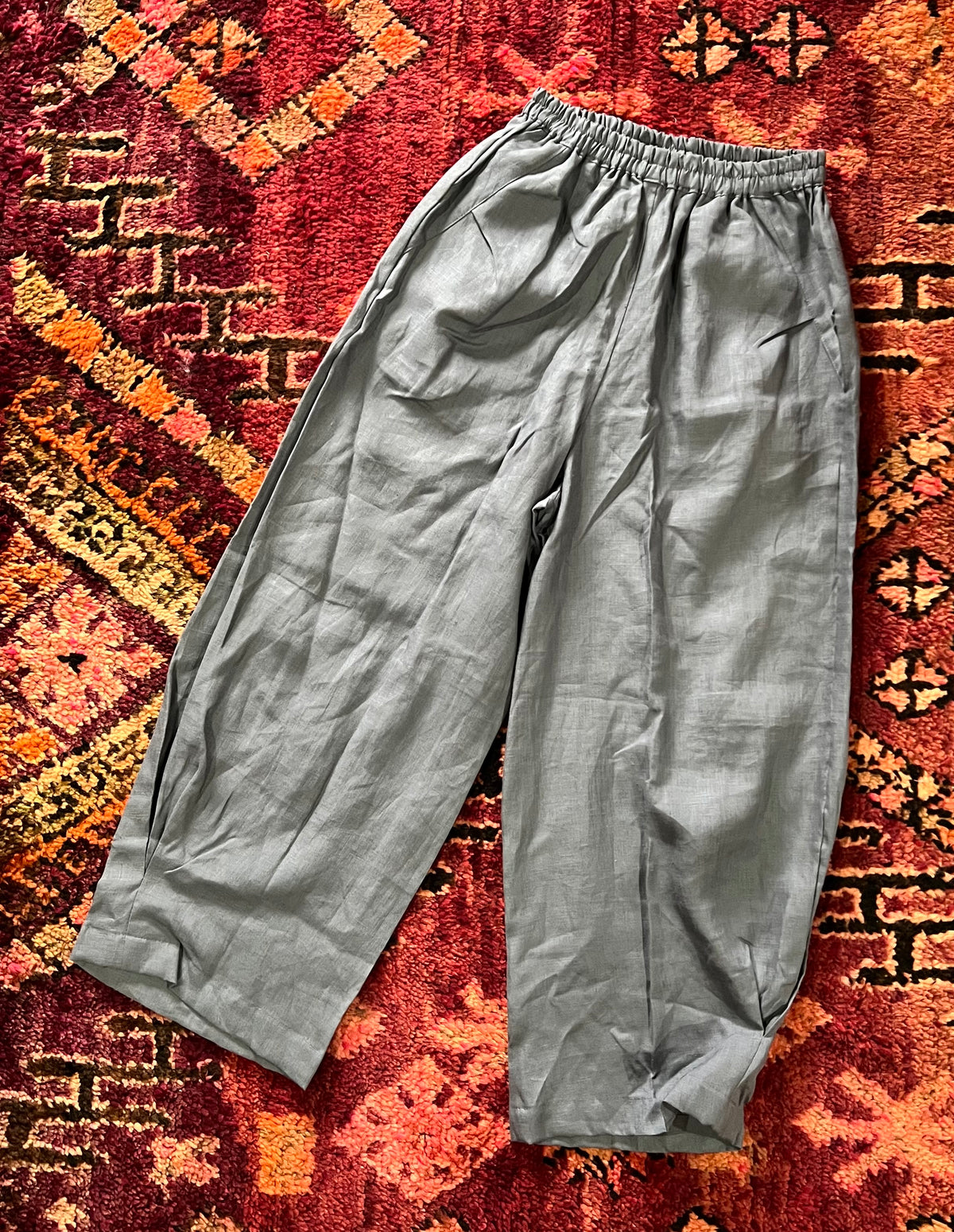 "Open Hearts Mend artisanal cotton/linen trousers with an elastic waistband, pockets, cropped silhouette, and hand-dyed finish for unique style and sustainability."