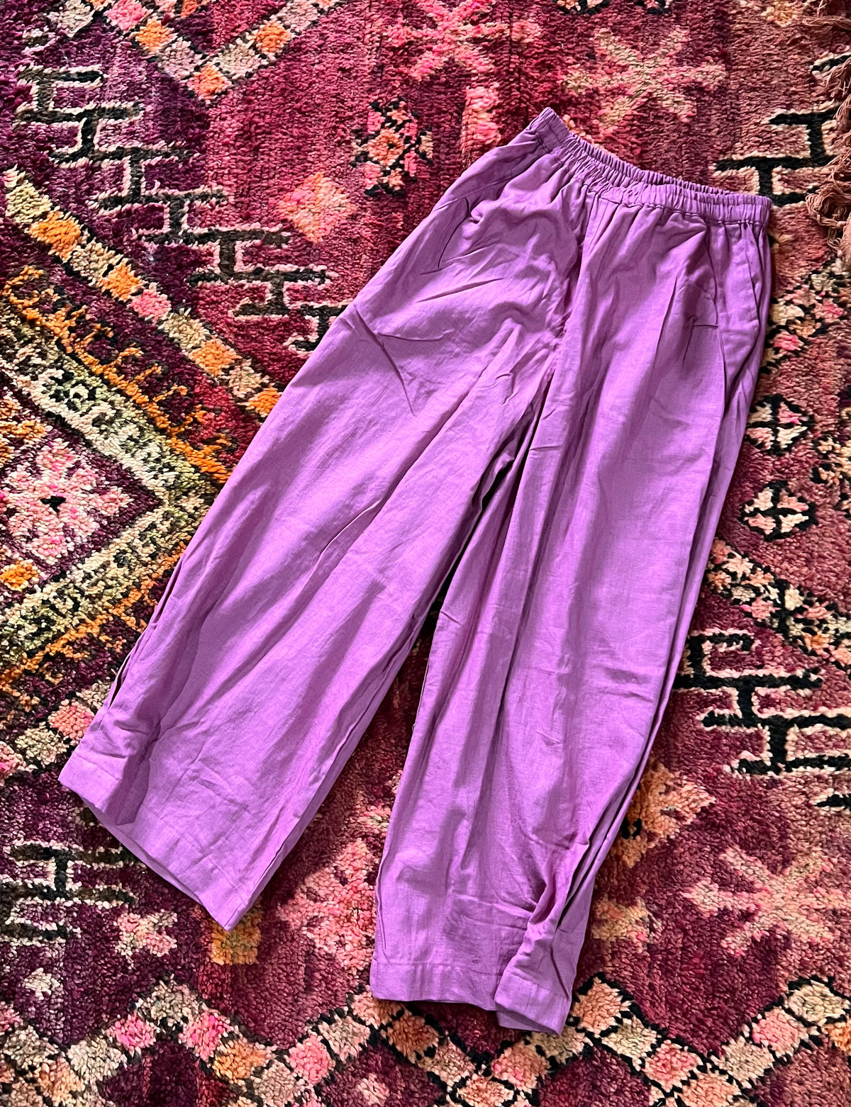 "Open Hearts Mend artisanal cotton/linen trousers with an elastic waistband, pockets, cropped silhouette, and hand-dyed finish for unique style and sustainability."