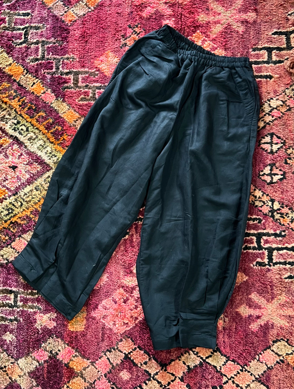 "Open Hearts Mend artisanal cotton/linen trousers with an elastic waistband, pockets, cropped silhouette, and hand-dyed finish for unique style and sustainability."