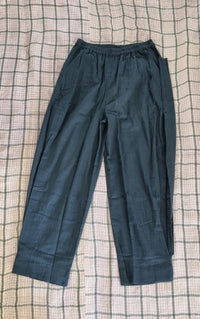 "Open Hearts Mend artisanal cotton/linen trousers with an elastic waistband, pockets, cropped silhouette, and hand-dyed finish for unique style and sustainability."