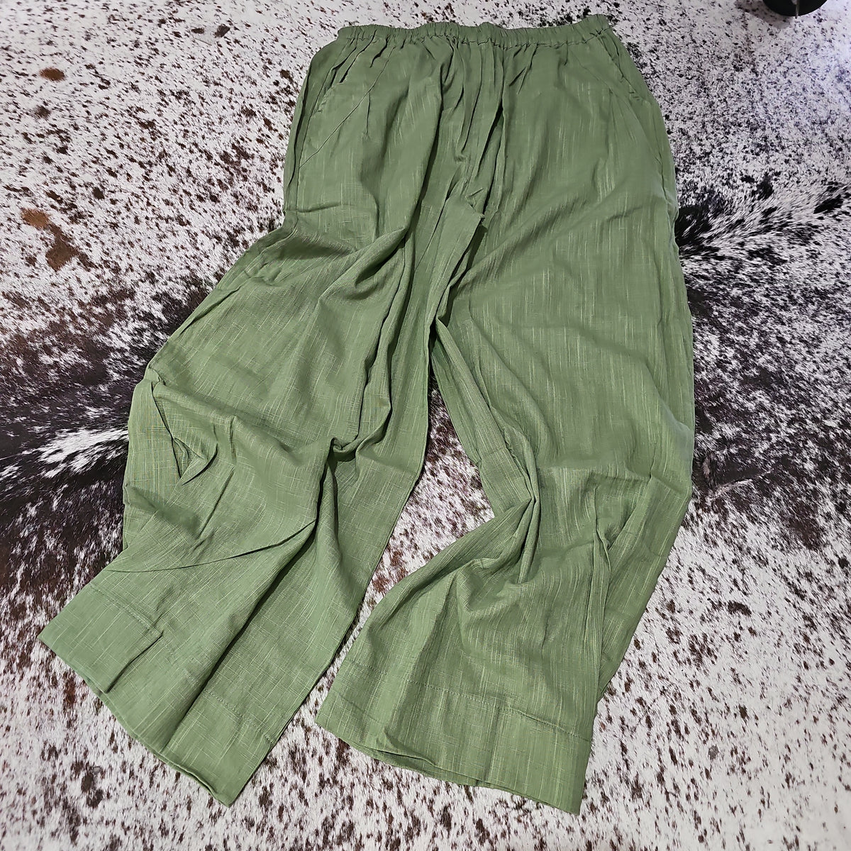 "Open Hearts Mend artisanal cotton/linen trousers with an elastic waistband, pockets, cropped silhouette, and hand-dyed finish for unique style and sustainability."