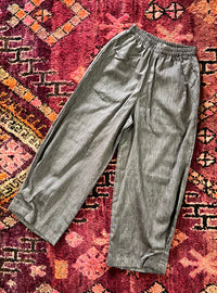 "Open Hearts Mend artisanal cotton/linen trousers with an elastic waistband, pockets, cropped silhouette, and hand-dyed finish for unique style and sustainability."