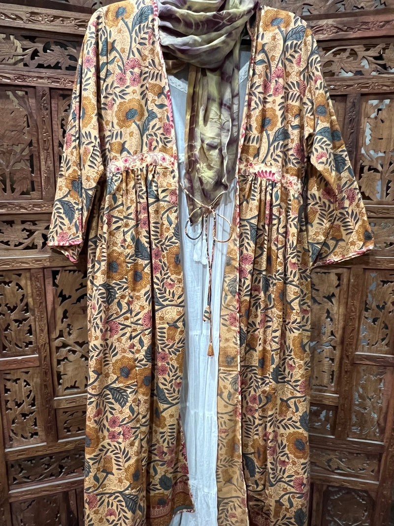 "Floral Printed Cotton Duster Coat with forearm-length sleeves and knee-length design, perfect for layering in any season."