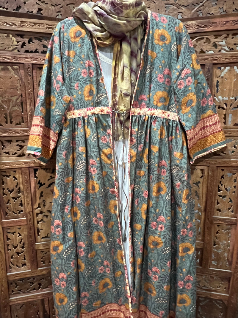 "Floral Printed Cotton Duster Coat with forearm-length sleeves and knee-length design, perfect for layering in any season."