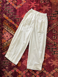 "Open Hearts Mend artisanal cotton/linen trousers with an elastic waistband, pockets, cropped silhouette, and hand-dyed finish for unique style and sustainability."