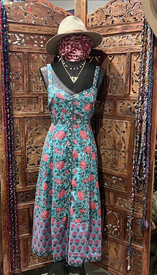 Lightweight cotton summer dress with block print, covered buttons, and breezy silhouette. Available in sizes SM (6-8) and ML (10-12). Paired with a fashionable bomber jacket and soft scarf for a chic, versatile summer look.