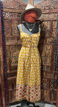 Lightweight cotton summer dress with block print, covered buttons, and breezy silhouette. Available in sizes SM (6-8) and ML (10-12). Paired with a fashionable bomber jacket and soft scarf for a chic, versatile summer look.