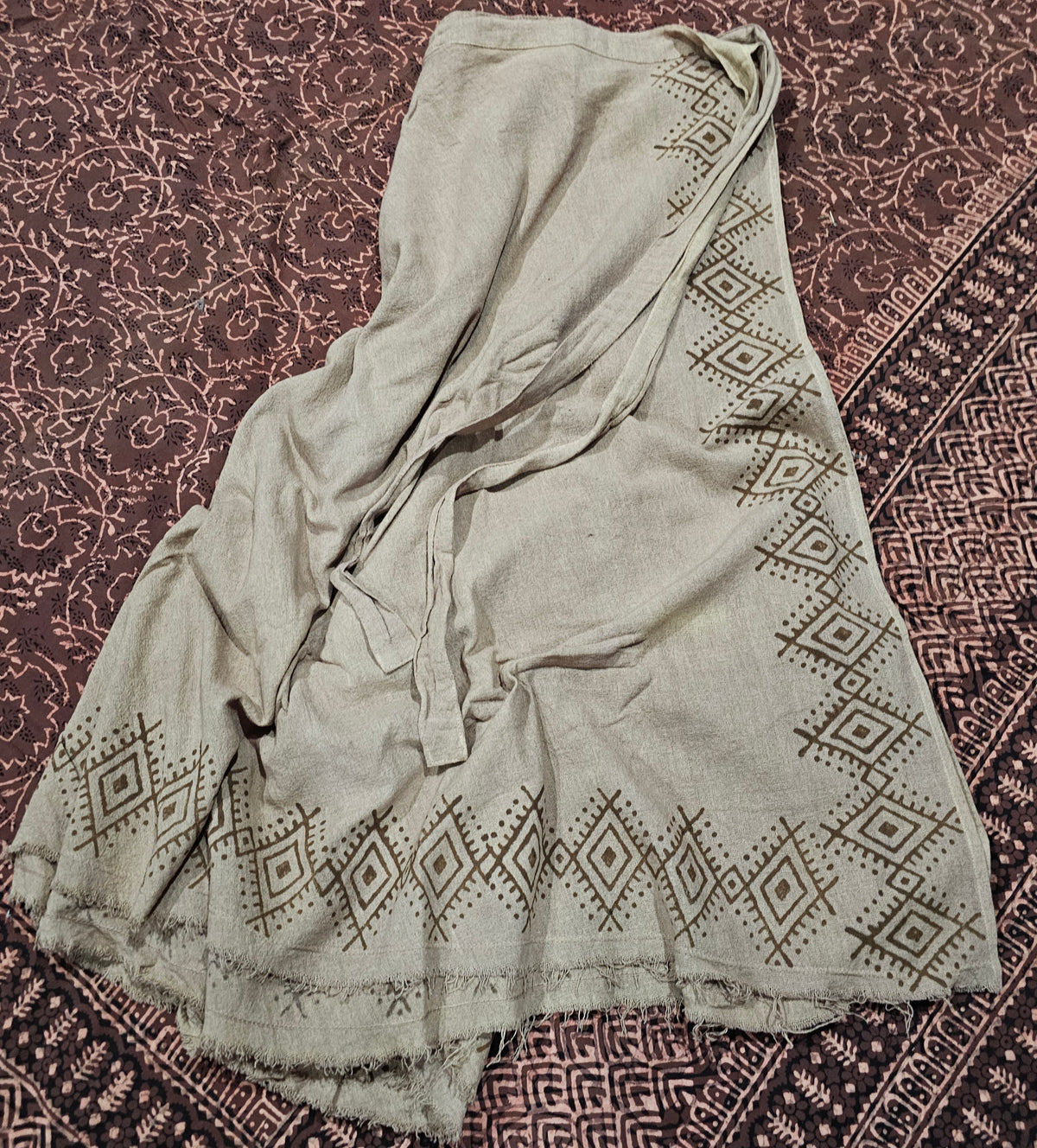 &nbsp;Block Printed Edge Wrap Skirt from Open Hearts Mend, crafted with hand-woven cotton and uniquely dyed in earthy tones. Approximately 90cm long, suitable for sizes 8 to 16.